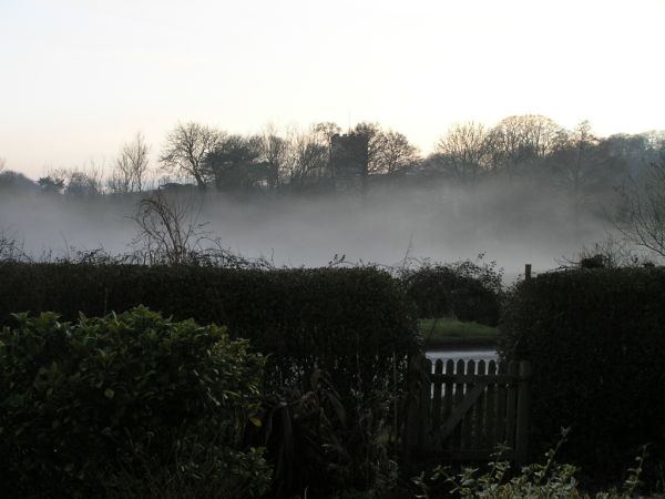 Church beyond meadow mist on 23rd December 2007