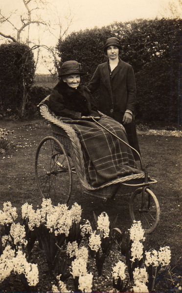 Maria Burrough (in Bath chair) and possibly Elsie Dicks about 1920 at Barn Orchard